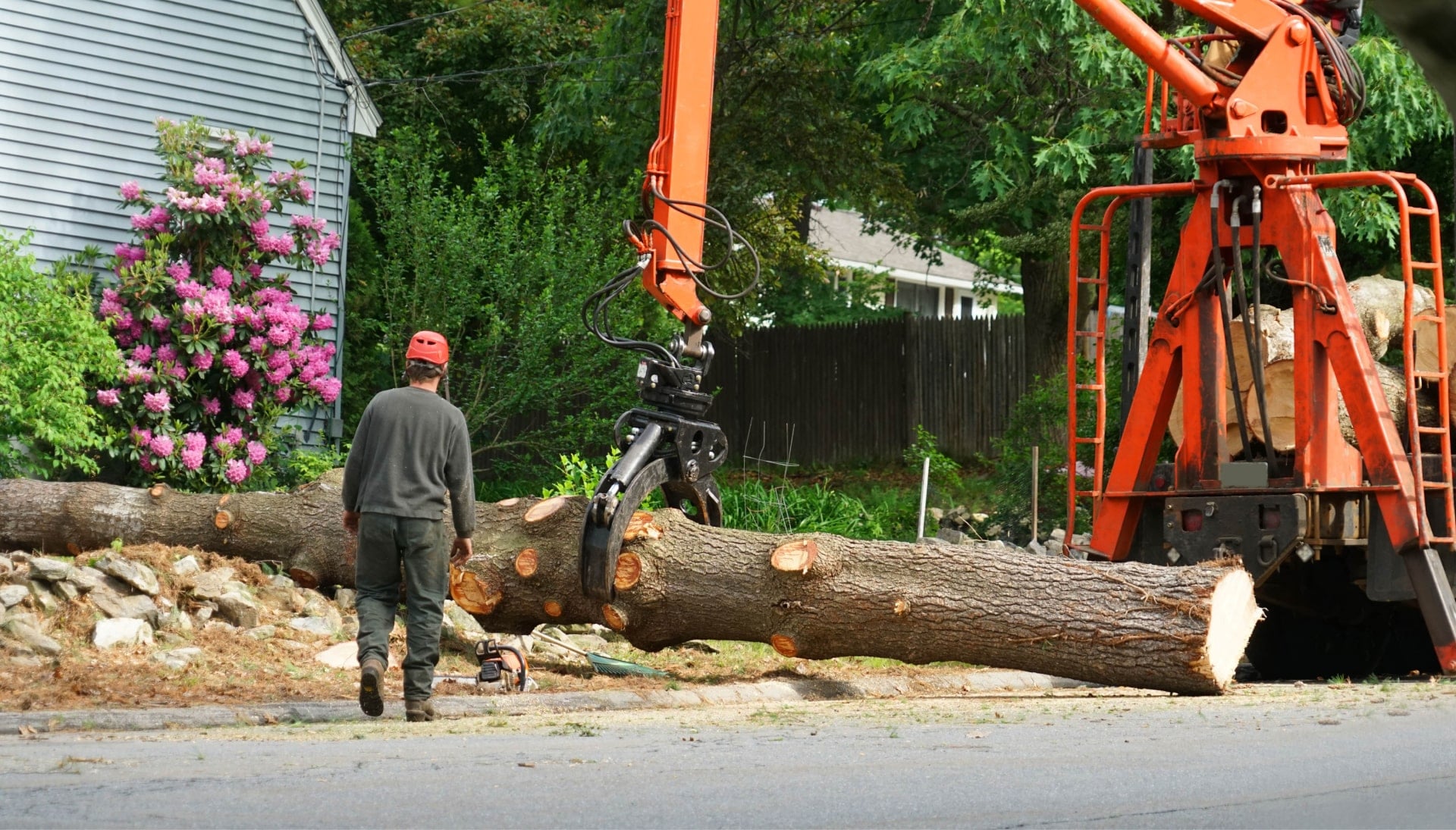 A tree removal service vehicle picks up stump in Athens, Georgia